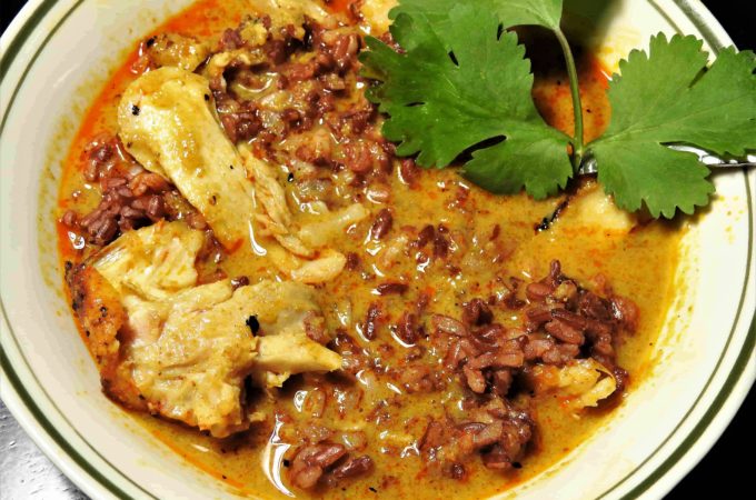 Curry gravy over grilled chicken and ruby red rice with Thai curry gravy